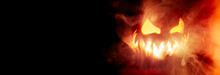 Scary Halloween Jack O Lantern Face Glowing In Smoke And Fire With Blank Copy Space For Text.