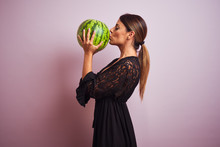 Young Beautiful Hispanic Woman Wearing Black Dress Holding Watermelon