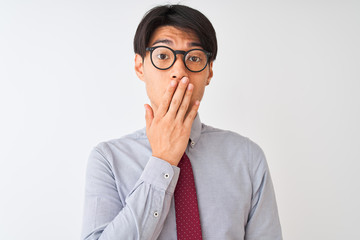 Wall Mural - Chinese businessman wearing tie and glasses standing over isolated white background cover mouth with hand shocked with shame for mistake, expression of fear, scared in silence, secret concept