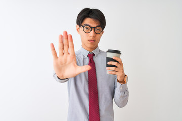 Poster - Chinese businessman wearing tie and glasses drinking coffee over isolated white background with open hand doing stop sign with serious and confident expression, defense gesture