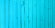 Background of wooden narrow vertical boards of cyan color. The blue texture of the wood. Used for furniture production, design and manufacture of laminate, parquet, fence.
