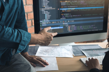 Developing programming and coding technologies working in a software engineers developing applications together in office.