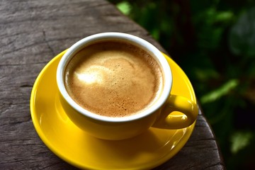 Cup of hot coffee on the wooden floor in the morning