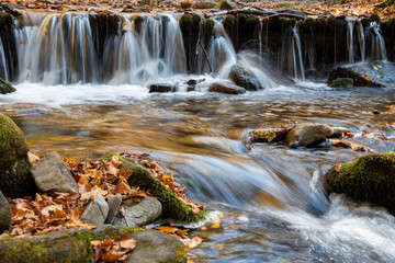 Wall Mural - Colorful majestic waterfall in autumn forest