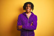 © Krakenimages.com - Afro american man with dreadlocks wearing purple sweatshirt over isolated purple background happy face smiling with crossed arms looking at the camera. Positive person.