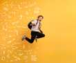 © alphaspirit - Young boy student runs fast to escape from school. Yellow background