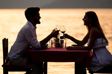 Wall Mural - Couple sharing romantic sunset dinner on tropical resort