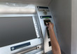 © Germanova Antonina - hand of a boy pokes a card at an ATM