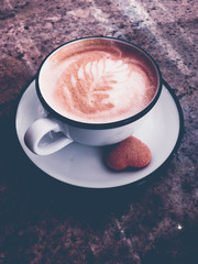 Cappuccino for breakfast in cafeteria, coffee cup on table in parisian cafe