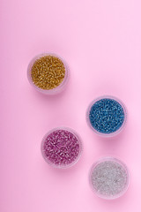 Canvas Print - Seed beads on pink background flat lay