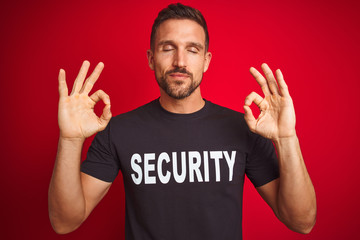 Poster - Young safeguard man wearing security uniform over red isolated background relax and smiling with eyes closed doing meditation gesture with fingers. Yoga concept.