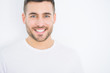 © Krakenimages.com - Young handsome man smiling happy wearing casual white t-shirt over white isolated background