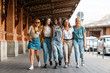 © Adrian - Group of five women walking together in the street