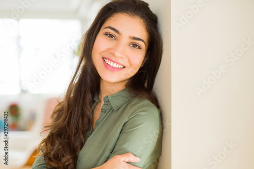 Cuadros en Lienzo Beautiful brunette woman smiling cheerful, looking happy and positive with cross