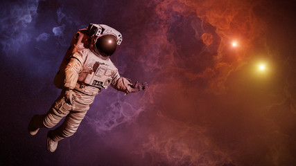 Canvas Print - astronaut in colorful nebula close to a binary star system
