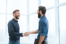 Business People Shaking Hands In A Bright Office