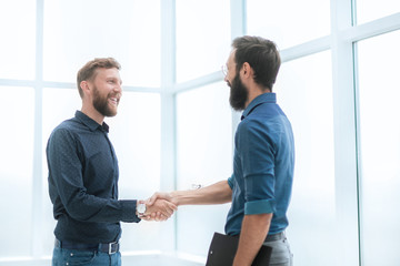 business people shaking hands in a bright office