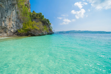 Phi Phi, Maya beach with blue turquoise seawater, Phuket island in summer season during travel holidays vacation trip. Andaman ocean, Thailand. Tourist attraction with blue cloud sky.