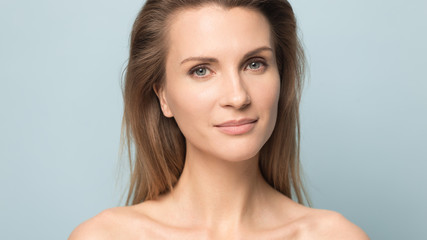 close up portrait of blonde millennial woman looking at camera