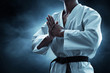 © fotokitas - Karate martial arts fighter on dark background