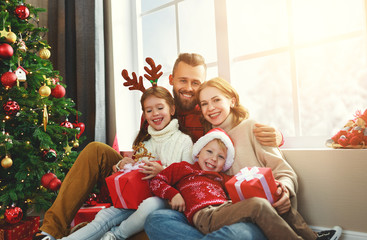 happy family   open presents on Christmas morning