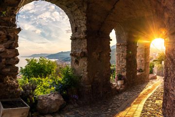 The sunset seen from an alley of the borough og Borgio Verezzi, Pietra Ligure, Liguaria, Italy