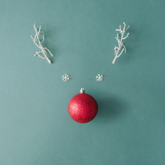 santas reindeer made with christmas bauble decoration and white snowy winter branches. minimal flat 