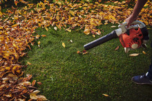 A Man Working With A Leaf Blower