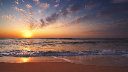 Wall Mural - golden sea sunrise and washing waves on the beach