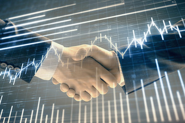 Multi exposure of forex graph on abstract background with two businessmen handshake. Concept of success on stock market