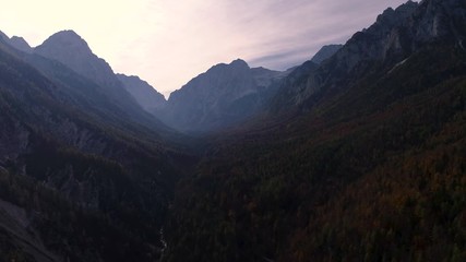 Wall Mural - mountain view of alpine peaks and forest and sunset sky