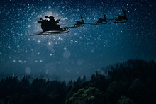 Silhouette Of A Flying Goth Santa Claus Against The Background Of The Night Sky.