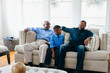 © Gerald Carter/Creative Flame - Grandfather, son, and grandson sitting together at home