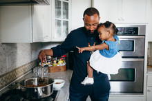Father Preparing Food With Daughter