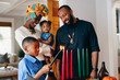 © Gerald Carter/Creative Flame - Boy lights candle to celebrate Kwanzaa