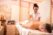 Masseuse applying movable pressure during a massage