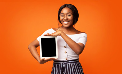 Black Girl Showing Tablet Blank Screen Over Orange Background, Mockup