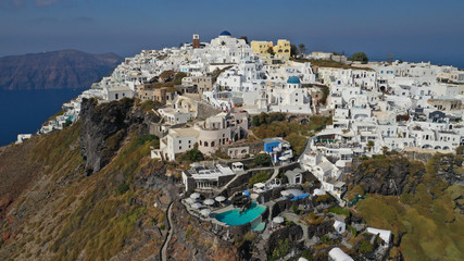 Aerial drone photo of iconic picturesque village of Imerovigli built on top of steep hill with amazing views to Caldera and Santorini island, Cyclades, Greece