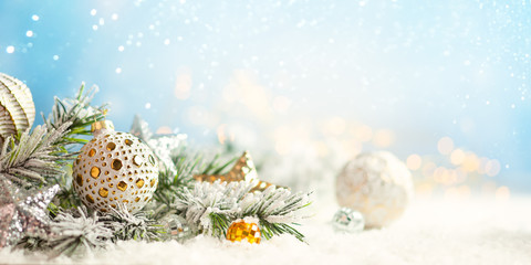 Wall Mural - christmas winter background with christmas baubles and fir tree branches on snow.