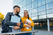 © cherryandbees - students holding book outdoor in font of university building