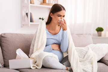 Wall Mural - Sick Pregnant Lady Blowing Nose Sitting On Couch At Home