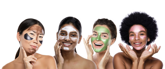 Wall Mural - Beautiful multi-ethnic group of girls with colorful peel-off masks on their faces