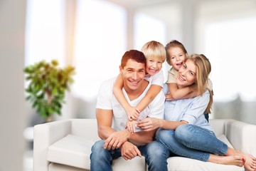 Wall Mural - Young family at home smiling at camera