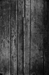 Wall Mural - Weathered and aged wooden door, wall or wood panelling in black and white with paint peeling off.