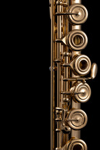 A Part Of A Gold Plated Flute On A Black Background. An Instrument Common In The Symphony Orchestra
