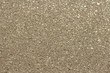 Background of brillant golden natural sand with glitter and sequins.