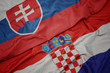 © luzitanija - waving colorful flag of croatia and national flag of slovakia.