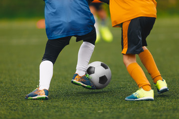 Closeup of Boys Kicking Soccer Ball. Running Soccer Football Players. Junior Footballers on Duel