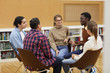 © Seventyfour - Multi-ethnic group of young people sitting in circle and sharing ideas during class in college, copy space