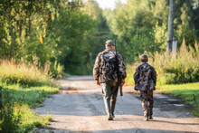 Father Pointing And Guiding Son On First Deer Hunt